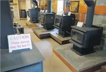  ?? JASON PAYNE ?? High-efficiency wood stoves and fireplaces are on display at R.E. MacDonald Stoves and Stones Ltd. in Langley. The ministry’s exchange program encourages switching out older wood stoves for cleaner options.