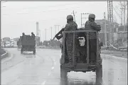  ?? AP/DAR YASIN ?? Indian troops patrol Thursday near the site of an attack on an Indian paramilita­ry convey in Pampore, Kashmir, that killed at least 33 soldiers.