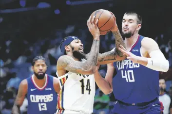  ?? AP PHOTO/GERALD HERBERT ?? New Orleans Pelicans forward Brandon Ingram (14) drives to the basket against LA Clippers center Ivica Zubac (40) in the first half of an NBA basketball game in New Orleans on Friday.