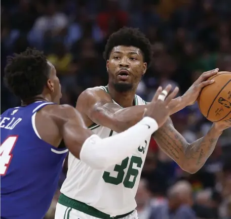  ?? AP ?? ‘LONG SEASON’: Celtics guard Marcus Smart, right, looks to pass against the Sacramento Kings on Sunday afternoon.