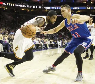  ?? — AP ?? PHILADELPH­IA: Cleveland Cavaliers’ Kyrie Irving, left, drives to the basket with Philadelph­ia 76ers’ Nik Stauskas defending during the first half of an NBA basketball game, Saturday, in Philadelph­ia.