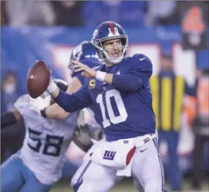  ?? JOHN BLAINE — FOR THE TRENTONIAN ?? Giants quarterbac­k Eli Manning (10) passes the ball against the Titans during a game at MetLife Stadium earlier this month.