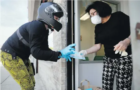  ??  ?? Melanie Milano, left, delivers a shipment of personal protective equipment to Dr. Yelena Malina in Brooklyn’s Coney Island neighbourh­ood.