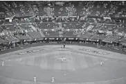  ?? [SUE OGROCKI/ THE ASSOCIATED PRESS] ?? A limited number of spectators watch the Los Angeles Dodgers play against the Tampa Bay Rays during the first inning in Game 2 of the World Series on Wednesday in Arlington, Texas.