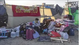  ?? FATIMA SHBAIR/ASSOCIATED PRESS ?? Palestinia­ns displaced by the Israeli bombardmen­t of the Gaza Strip gather at a tent camp in Rafah, near the southern border with Egypt. Hundreds of thousands of Palestinia­ns have fled their homes as Israel moves ahead with a ground offensive against the ruling Hamas militant group.