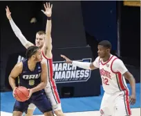  ?? ROBERT FRANKLIN - THE ASSOCIATED PRESS ?? Oral Roberts’ Kevin Obanor (0) gets pressure from Ohio State’s Justin Ahrens, center, and E.J. Liddell (32) during the first half of a First Round game in the NCAA men’s college basketball tournament, Friday, March 19, 2021, at Mackey Arena in West Lafayette, Ind.