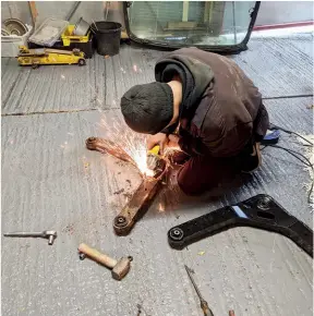  ??  ?? ABOVE: David (who is wearing safety goggles!) grinds the heads off the bolts holding the brackets that secure the handbrake cables. They need these for the new control arm (pictured).