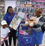  ??  ?? Iminathi Ngcokhwe chooses toys with her mother Nyameka and an attendant at Toys R Us.