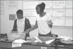  ??  ?? Teamwork: In Emily McDaniel’s class, WMS sixth graders Isaiah Singleton and Jaylah Davis work in assembly line fashion to build a computer.