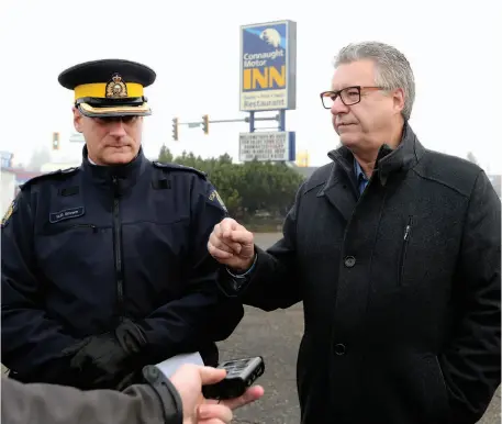  ?? CITIZEN PHOTO BY BRENT BRAATEN ?? RCMP Supt. Warren Brown and Mayor Lyn Hall speak about the reduction of crime after closing the Connaght Motor Inn on Friday.