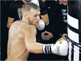  ?? JOHN LOCHER/ASSOCIATED PRESS FILE PHOTO ?? Conor McGregor, above, and Floyd Mayweather Jr. have been allowed to use 8-ounce gloves for their upcoming bout Aug. 26 in Las Vegas, Nev., but boxing regulators may have made the wrong decision.