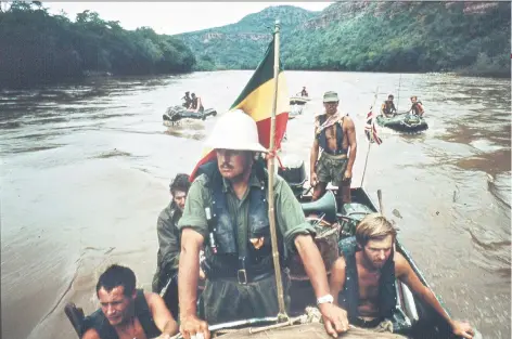  ??  ?? Tough going: Capt Blashford-snell on the Blue Nile near the end of the journey, above; giving covering fire while under attack from tribesmen, left, and today, below left. The Caption caption italic