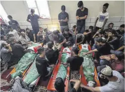  ?? Mahmud Hams / AFP ?? Palestinos en el funeral de cuatro miembros de una misma familia.