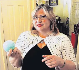  ?? STEPHEN MONTOYA/RIO RANCHO OBSERVER ?? Irene Leaton holds one of her company’s many products, a “Power Balm.” Leaton’s home business, Simple CBD Solution, specialize­s in creating holistic products in place of prescripti­on drugs.