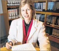  ?? AP PHOTO ?? Dr. Joann Manson poses with a printout from a study she directed on hormone replacemen­t therapy for women at her office in Boston.