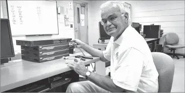  ??  ?? GNTC computer instructor Dwight Watt inspects networking hardware in a Walker County Campus networking lab.