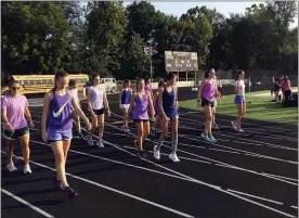  ?? BRIAN RIPPEY — READING EAGLE ?? The Berks Catholic girls cross country team wears purple in remembranc­e of former team manager Grace Hornickle.
