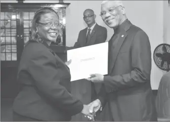  ?? (Ministry of the Presidency photo) ?? Attorney Rosalie Robertson being presented with her Instrument of Appointmen­t