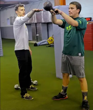  ?? Matt Freed/Post-Gazette ?? Rob Dulabon helps train Ultimate Frisbee player Micah Ziff, 15, of Fox Chapel, at his RODU gym in Larimer.