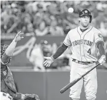  ?? Fred Thornhill / Canadian Press ?? George Springer doesn’t like the called strike in the eighth inning, but the Astros right fielder struggled at the plate Saturday with three strikeouts and one walk in a 4-2 loss to the Blue Jays in Toronto.