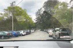  ?? Bob Doyle / Special to The Chronicle ?? Cars jam the parking lot and line the road at an entrance to Tilden Regional Park in the East Bay Regional Parks District.