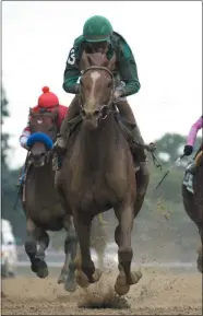  ?? RMP/NYRA ?? Code of Honor with hall of fame jockey John Velazquez up broke from the back of the pack and was hand ridden to the Dwyer Stakes victory Saturday afternoon at Belmont Park.