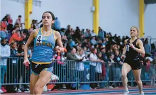  ?? ?? River Hill’s Marella Virmani leads the pack in the girls 4x800-meter relay at the Class 3A indoor track and field state championsh­ips at the Prince George’s Sports & Learning Complex in Landover on Wednesday.