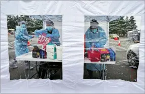  ?? TED S. WARREN — THE ASSOCIATED PRESS ?? Workers at a drive-up COVID-19testing clinic Jan. 4in Puyallup, Wash. Testing for COVID-19 has plummeted worldwide, making it much tougher for scientists to track the course of the pandemic and spot new viral mutants.