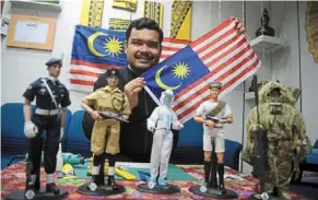  ?? — Photos: Bernama ?? Mohamad afiq has handmade a collection of 24 local heroes in full dress uniform.