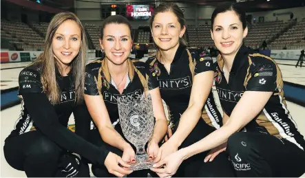  ?? DARREN MAKOWICHUK ?? The Homan rink, from left, Rachel Homan, Emma Miskey, Sarah Wilkes and Lisa Weagle, hold the Champions Cup after defeating Sweden’s Anna Hasselborg 5-4 on Sunday in Calgary.