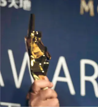  ??  ?? IRRFAN , who was adjudged the best actor for his performanc­e in “The Lunchbox”, poses with his trophy during the Asian Film Awards in Macau on March 27, 2014.