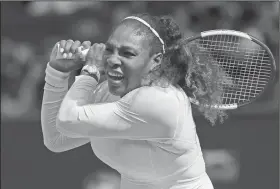  ?? Associated Press ?? Williams advances: Serena Williams returns to Julia Goerges in their women's semifinal match at the Wimbledon Tennis Championsh­ips in London Thursday.