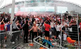  ?? Photograph: Lee Smith/Action Images/Reuters ?? Fans outside Wembley Stadium celebrate after England took the lead in the Euro 2020 final against Italy.