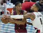  ?? TONY DEJAK — THE ASSOCIATED PRESS ?? The Trail Blazers’ Damian Lillard defends Isaac Okoro during the second half May 5.