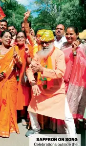  ??  ?? SAFFRON ON SONG Celebratio­ns outside the
BJP office in Bengaluru