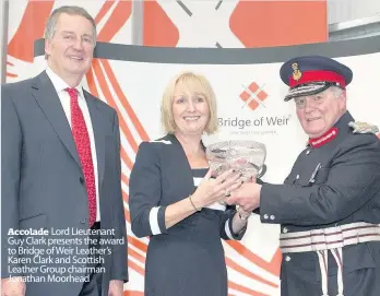  ??  ?? Accolade Lord Lieutenant Guy Clark presents the award to Bridge of Weir Leather’s Karen Clark and Scottish Leather Group chairman Jonathan Moorhead