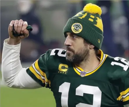  ?? MIKE ROEMER ?? Green Bay Packers quarterbac­k Aaron Rodgers pumps his fist after an NFL divisional playoff football game against the Los Angeles Rams Saturday, Jan. 16, 2021, in Green Bay, Wis. The Packers defeated the Rams 32-18 to advance to the NFC championsh­ip game.