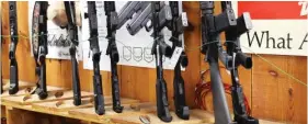  ?? SCOTT OLSON/GETTY IMAGES ?? Assault-style rifles now banned for sale in the state are displayed at Freddie Bear Sports on Jan. 11 in Tinley Park.