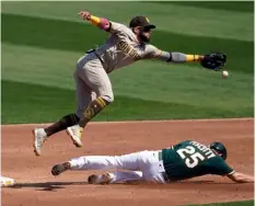  ?? AP Photo/Jeff Chiu ?? Oakland Athletics’ Stephen Piscotty (bottom) steals second base under San Diego Padres shortstop Fernando Tatis Jr. during the second inning of a baseball game in Oakland, Calif., on Saturday.