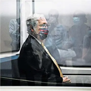  ?? JACQUELYN MARTIN/AP ?? Senate Majority Leader Mitch McConnell wears a mask as he rides the subway to a meeting Tuesday on Capitol Hill.