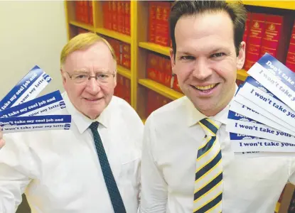  ??  ?? HAVING A DIG: Senators Ian Macdonald and Matt Canavan with cheeky pro- coal stickers.