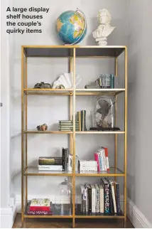  ??  ?? A LARGE DISPLAY SHELF HOUSES THE COUPLE’S QUIRKY ITEMS