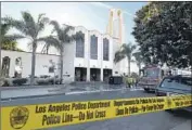  ?? Mark Ralston AFP/Getty Images ?? POLICE crime-scene tape surrounds fire-damaged Resurrecti­on Catholic Church in Boyle Heights.