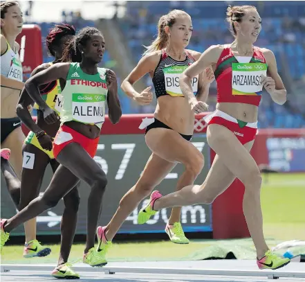  ?? — THE ASSOCIATED PRESS ?? Canada’s Melissa Bishop, centre, had the fastest qualifying time in the qualifying heats of the women’s 800 metres at Olympic Stadium in Rio Wednesday. Semifinals go Friday morning.