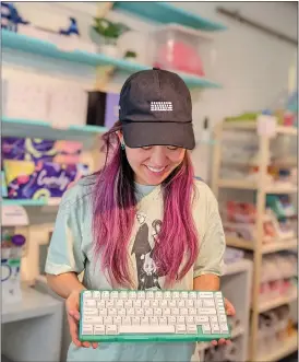  ?? COURTESY OF TINY KEYBOARD SHOP ?? Tiny Keyboard Shop owner “Tiny,” who didn't divulge a last name, holds a keyboard shortly after opening the shop in San Jose in August 2022. The site offers customizab­le keyboards.