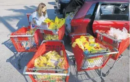  ??  ?? Norita Sandigo shops for families at Sedanos Supermarke­t before heading to Homestead. She brings care packages regularly to immigrant families all over South Florida.