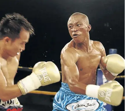  ?? / ANTONIO MUCHAVE ?? Julius Alcos and Gideon Buthelezi exchange the leather in this file picture at Emperors Palace. Boxing SA has paid Buthelezi part of the money for the July 27 tournament in East London.