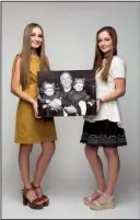  ?? The Washington Post/CHAD KIRKLAND ?? Twins Lindsay (left) and Kate Handy were photograph­ed in Provo, Utah, with then-Republican presidenti­al candidate Texas Gov. George W. Bush on March 9, 2000, during a campaign rally. The girls, now 17, are in their last year of high school.