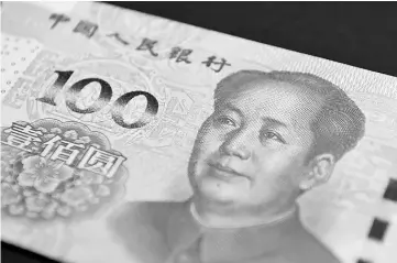  ??  ?? The image of former Chinese leader Mao Zedong is displayed on a one-hundred yuan banknote at the Bank of China Hong Kong headquarte­rs in Hong Kong, China, on Nov 12, 2015. — WP-Bloomberg photo