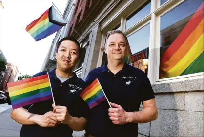  ?? Arnold Gold / Hearst Connecticu­t Media ?? Blue Orchid owners Kyu Tipjak, left, and his husband, Michael Flora, are photograph­ed outside their restaurant on Court Street in New Haven.